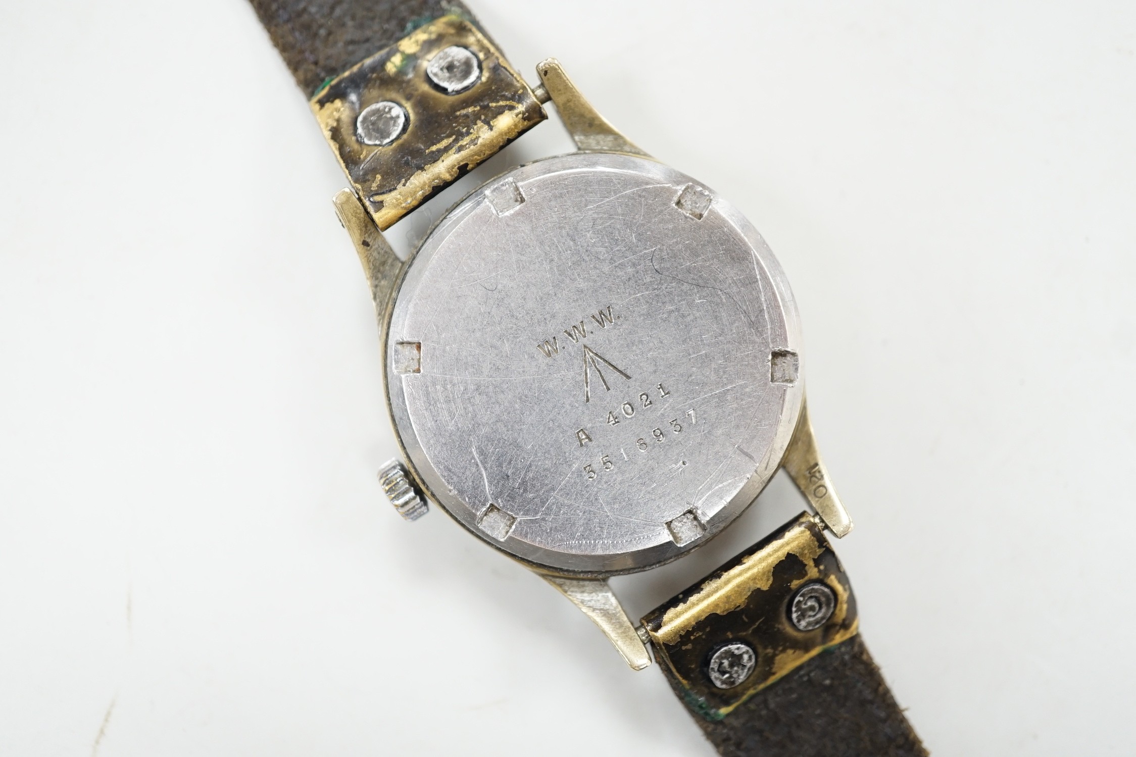 A gentleman's 1940's/1950's military issue steel Vertex manual wind black dial wrist watch (one of the 'dirty dozen' watches), the case back engraved WWW with broad arrow and numbered A 4021 3516937, on a leather strap,